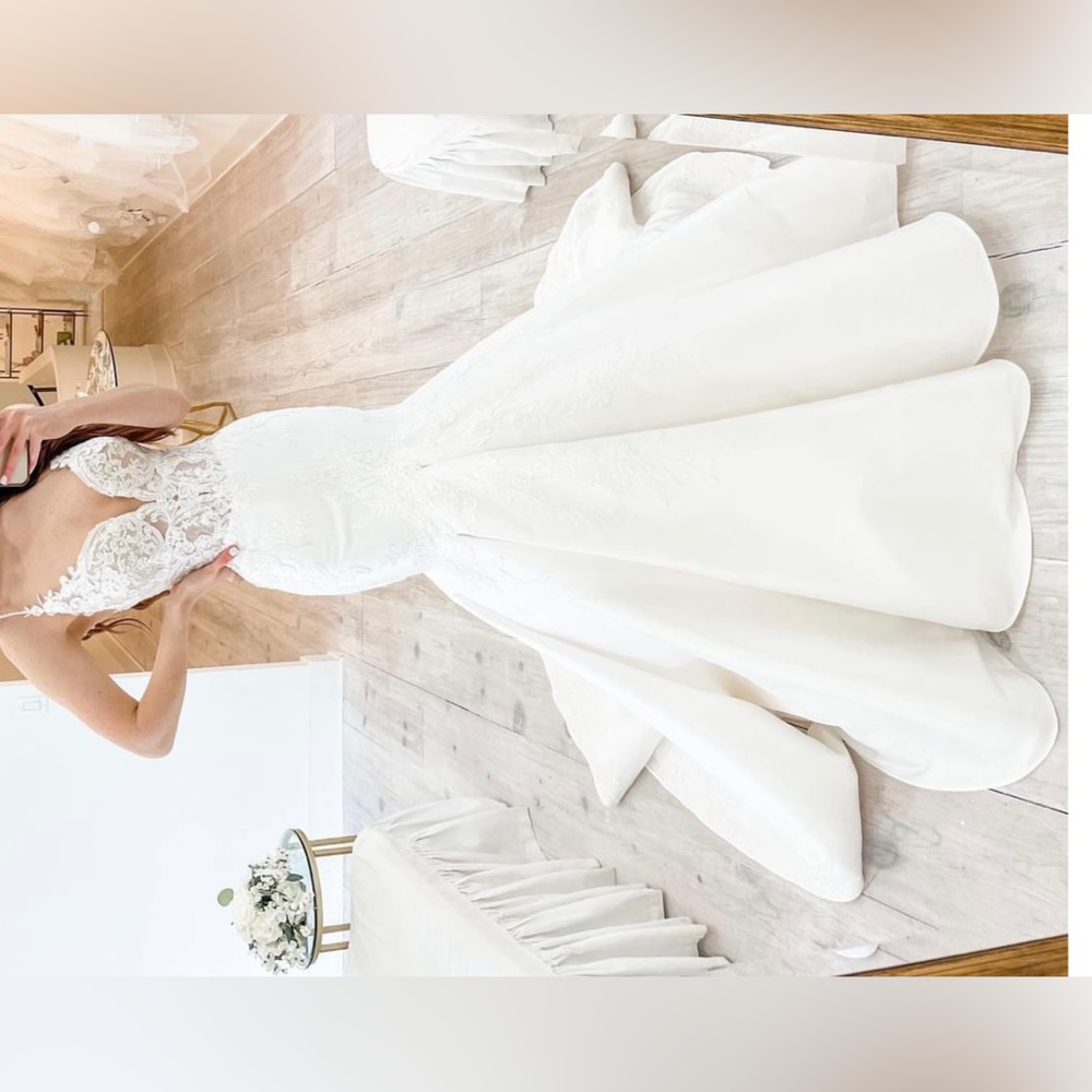 Brand NEW wedding dress. Never worn. No alterations. Original garment bag & tags